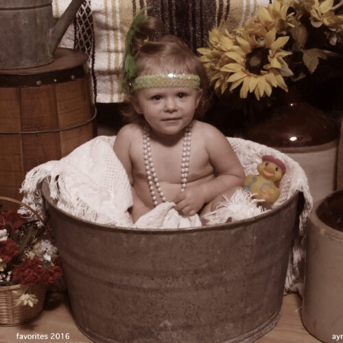 Young Girl Playing in a Tub